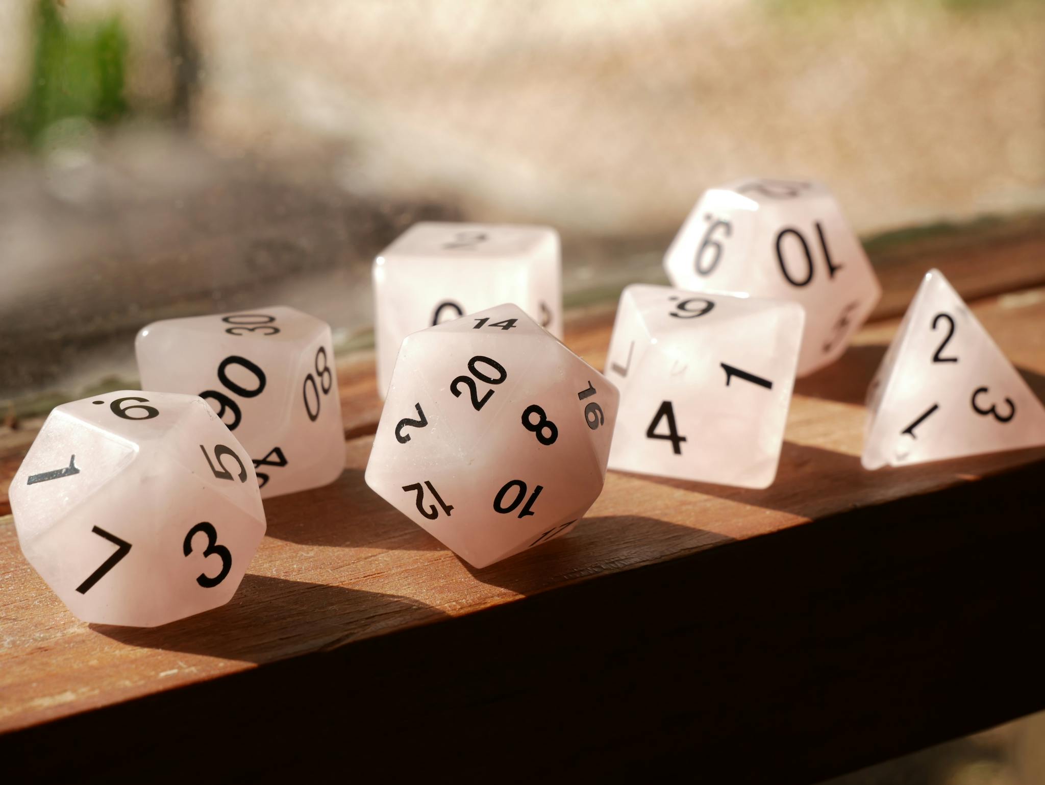 High-quality image of polyhedral dice on a wooden surface, perfect for gaming enthusiasts.